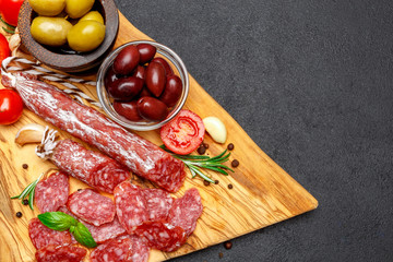 Dried organic salami sausage on wooden cutting board