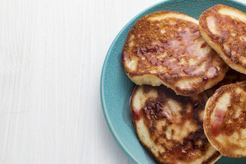 pancakes with cherry jam on a plate
