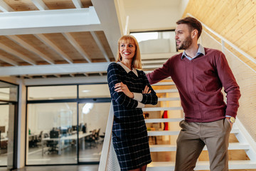 Shot of two colleagues standing in an office building