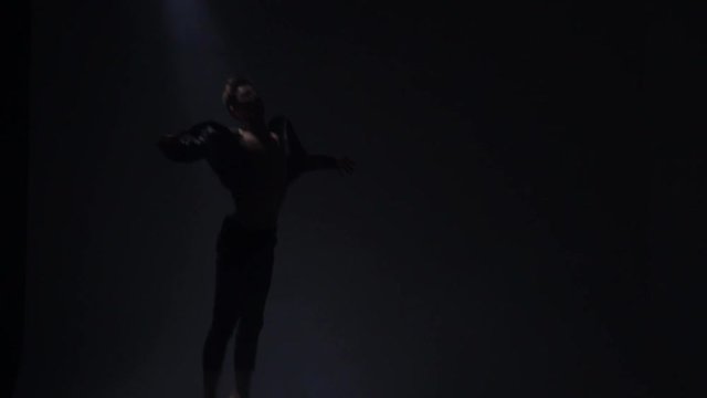 A ballet dancer shows a ballet jump pas de chat, slow motion