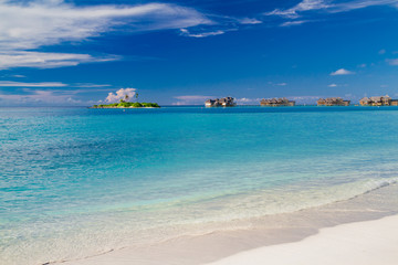 Luxury water villas in Maldives island. Clear blue sea and white sand. Luxurious summer vacation and holiday concept