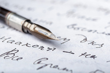 Fountain pen on an antique handwritten letter