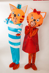 Young girl and guy in the chic costumes of cats