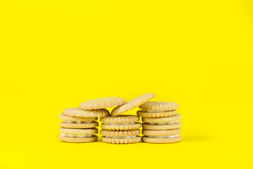 Pile of Cookies, Biscuits on a Bright Yellow Background