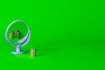 Money Reflected in Mirror - Saving Investment Concept on a Green Background