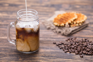 Milk is poured into coffee