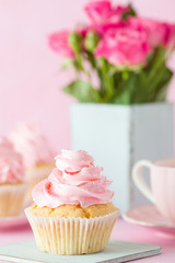 Pink pastel vertical banner with decorated cupcakes, cup of coffe with milk and bouquet of pink roses.
