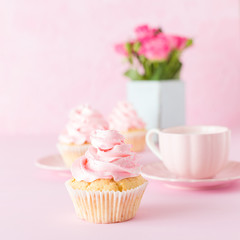 Pink pastel banner with decorated cupcakes, cup of coffe with milk and bouquet of pink roses.