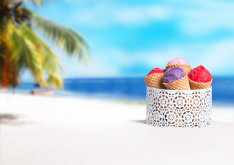 Fototapeta na wymiar Ice cream, Blueberry and strawberry ice cream scoop in cone on sand with beach background.