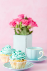 Pink pastel vertical banner with decorated cupcakes, cup of coffe with milk and bouquet of pink roses.