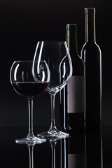 Bottles and glass of red wine .