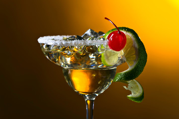 Alcoholic cocktail with cherry and lime.