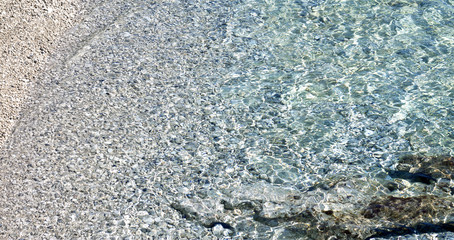 Pebbles and rocks under crystal clear sea. Island of Brac, Croatia