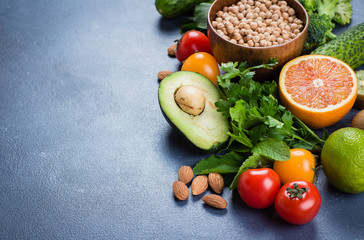 Healthy Food Clean Concept. Raw fruits, Vegetables, Nuts, Cereals on Concrete Stone Table Background. Copy space