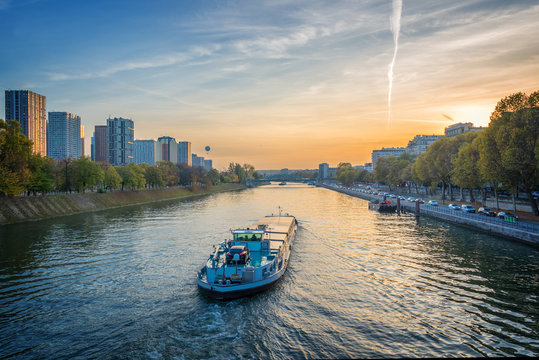 Barge on the river Seine at sunset, Paris France