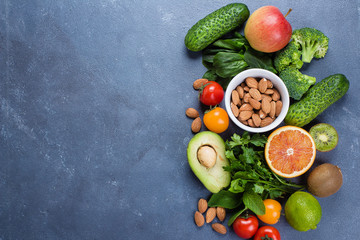 Healthy Food Clean Concept. Raw fruits, Vegetables, Nuts on Concrete Stone Table Background. Border, top view, copy space