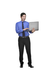 Image of asian businessman holding laptop while standing