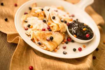 Blackberries jam with pancakes and powdered sugar