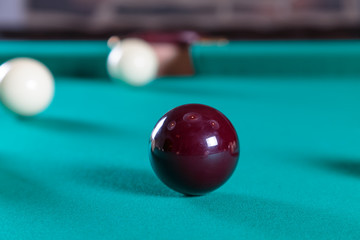balls for Russian Billiards on a billiard table with a green cloth