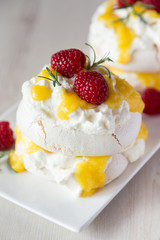 Raspberries on top of pavlova cake