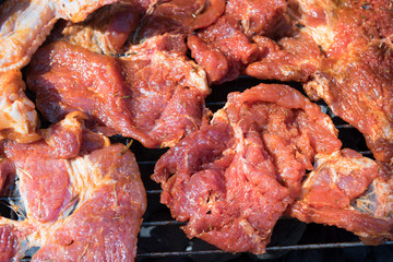 
meat on a hot grill with smoke