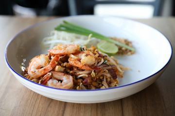 Pad thai with shrimp . Thai food on wood background