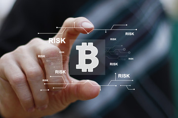 Businessman presses button bitcoin risk on virtual digital electronic user interface icon.