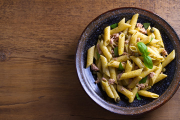 Tuna, basil and caper penne. Pasta with tuna fish. View from above, top studio shot