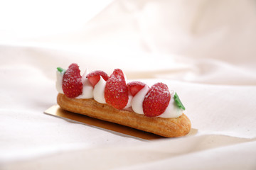 Choux cream with strawberry isolated in white background