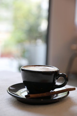 Cappuccino coffee cup on white fabric background