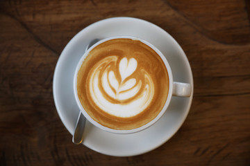 Cappuccino coffee cup on wood background