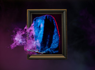 abstract colorful smoke from silhouette inside wooden frame on dark background