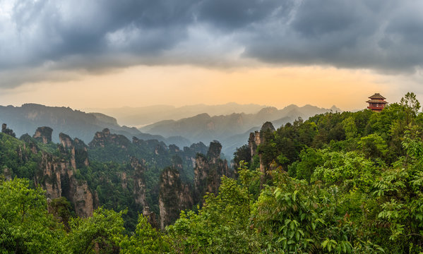 Pagoda on the hill sunset panorama with rocky mountains in the background and forest in the foreground,  Zhangjiajie national park, Hunan province, China