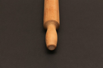 Rolling pin  on a dark background. Free space for text