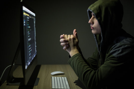 Dangerous Hooded Hacker Breaks into Government Data Servers and Infects Their System with a Virus. His Hideout Place has Dark Atmosphere.