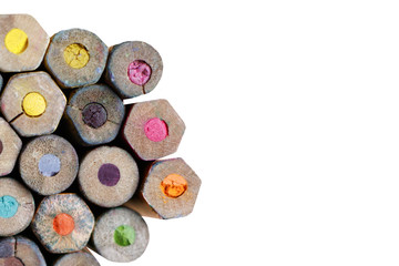 Many old colored pencils. View from above. Isolated over white background