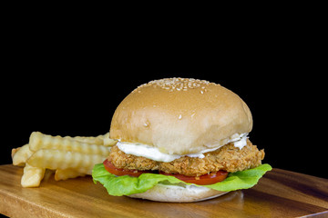 Chichen Crisp Burger and french fried on black background
