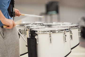 Drummer Playing Tenor Drums in a drum band during a show performance.