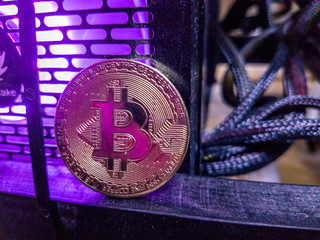 Bitcoin with coins on computer board and copy space using as background technology, money finance, business concept.