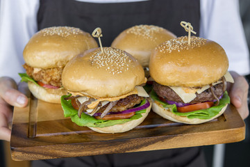 Four Burger on on cutting board