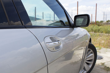 Right door handle car . side view mirror and door of silver sports  modern car. concept of transportation. close up