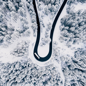 Aerial view of road passing through snowy landscape