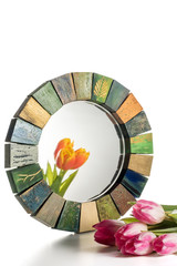 Interior design mirror handmade in wooden frame with bouquet of spring tulips