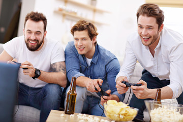 Friends having fun on the couch with video games