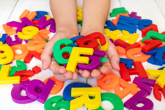 Child Learning Using Magnetic Letters And Numbers