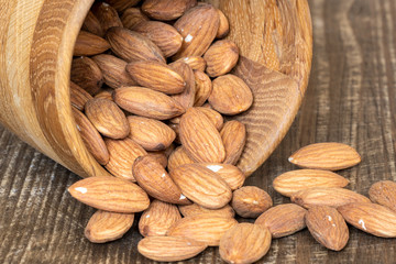 Peeled almonds in a wooden bowl