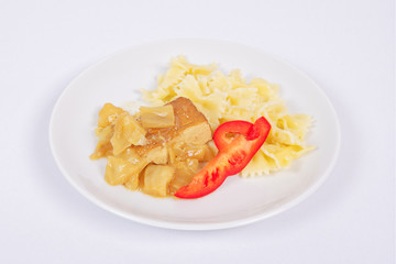Tofu with vegetables and pasta on a white