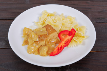 Tofu with vegetables and pasta on a table