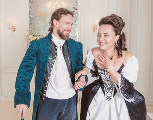 Beautiful couple woman and man in medieval clothes having fun