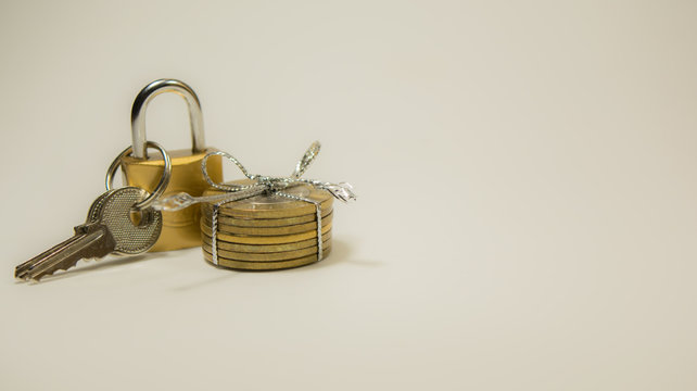 Indian 10 Rupee Coins tied and pad locker with keys on isolated white ackground